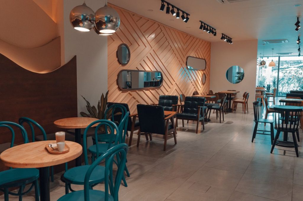 Explore a modern cafe interior featuring stylish chairs, tables, and lighting design.